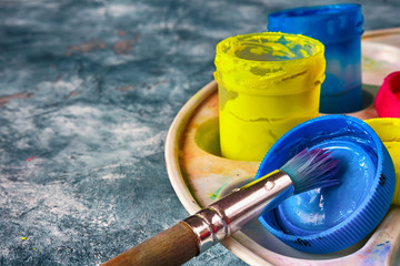 Gouache paints and art brushes for the artist with a copy space