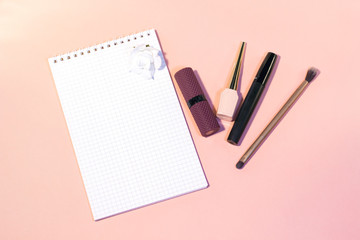 white notebook,purple lipstick,eyeliner 