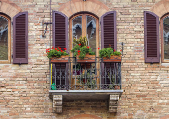 Traditional balcony on the old house in San Gimignano, Italy