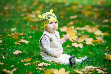 Little girl with autumn leaf