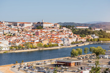 Fototapeta na wymiar Cityscape view on the old town of Coimbra city with Mondego river during the sunny day in the central Portugal