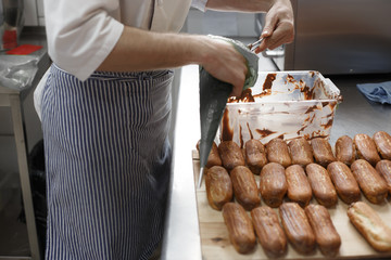 Men cooking chocolate eclair
