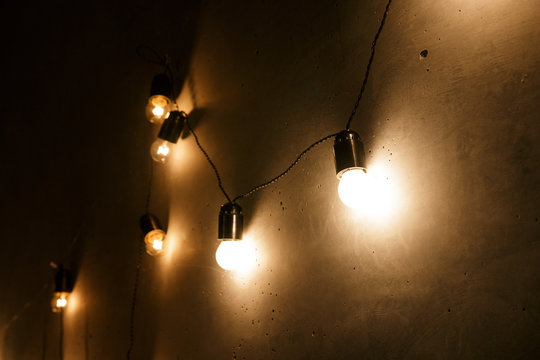 a garland of electric bulbs hanging on the wall
