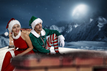 Obraz premium Christmas elf. Roof with chimney. Mountain view with snow and moon. December night. Christmas Eve.