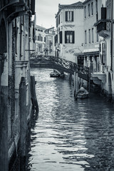 Fototapeta premium Canal in Venice, Italy. Venice cityscape, narrow water canal and traditional buildings. Italy, Europe. Italy beauty, silence on typical canal street in Venice, Venezia. Black and White photo.