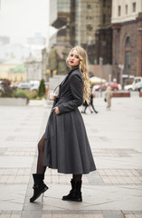 Portrait of a young beautiful woman in gray coat