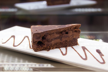Chocolate cake on plate on wood table