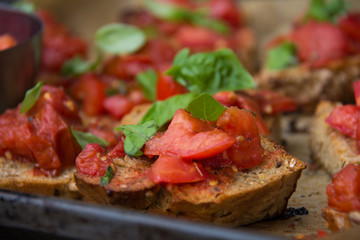 One ounce bruschetta with roasted tomatoes with basil and olive oil and spices