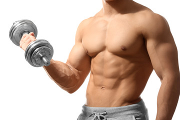 Fototapeta na wymiar Muscular young man with dumbbell on white background