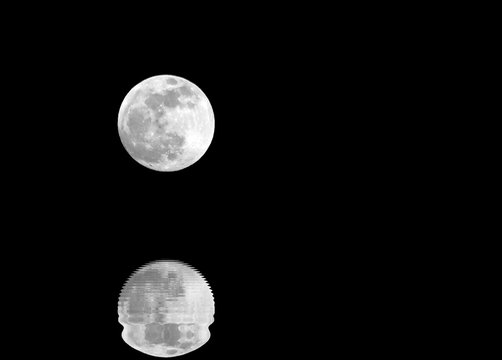 full moon and lunar reflection on the surface of the water with