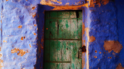 Blue city, Jodhpur, Rajasthan, India. Blue houses, background. Bright blue streets and walls. Popular tourist city in India. Old vintage wood carved door. Indian style.