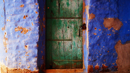Blue city, Jodhpur, Rajasthan, India. Blue houses, background. Bright blue streets and walls. Popular tourist city in India. Old vintage wood carved door. Indian style.