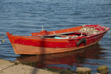 red boat moored in the port of Combarro