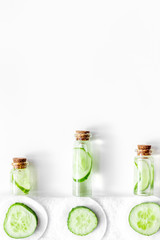 Lotion with cucumber pattern. White background top view copyspace