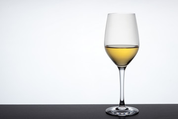 Glass of white wine over background with copy space