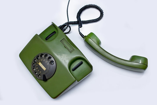 old green telephone on white background