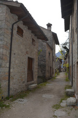 Fototapeta premium A small street in the hill village of Erto in Friuli Venezia Giulia, north east Italy.