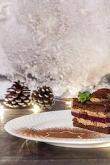 Piece of cake on a wooden table with pine cones