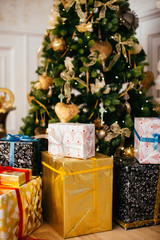 Decorated Christmas tree with packed presents boxes
