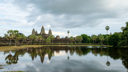 Fototapeta na wymiar Angkor Wat with rain cloud and refection in lake, Siem Reap, Cambodia