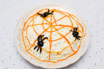 vegetable salad decorated with carrots and olives