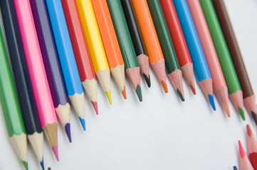 many multicolored pencils on white background