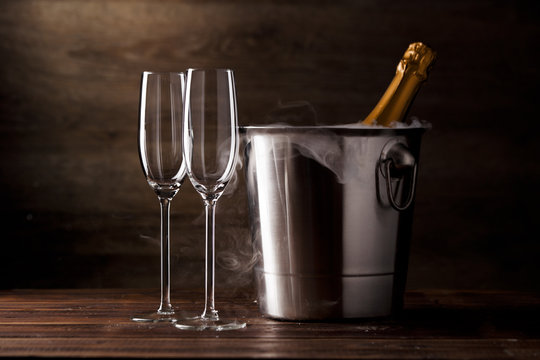 Image of two empty wine glasses, iron bucket