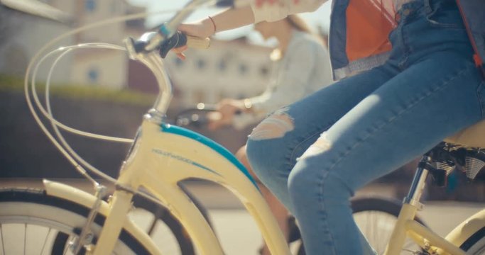 Close up of girl's legs twists pedals on a bicycle on the street shines the sun young pedal bicycling bike sport biking legs rider healthy lifestyle summer bm cycler extreme Slow Motion Shot
