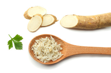 sliced horseradish root with parsley isolated on white background