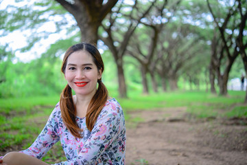 Fototapeta premium Portrait of thai woman under tunnel tree,asian woman in the forest
