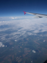 Fototapeta na wymiar aircraft wing flying above the earth