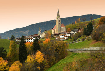 Fototapeta na wymiar The Church of Villandro in Autumn season. Bolzano, Italy.