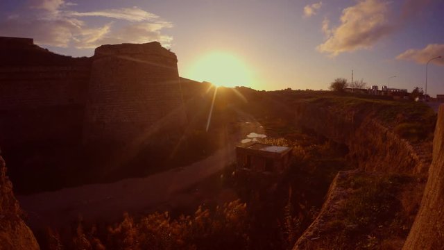 evening sun and a deep moat of the medieval fortress of Famagusta