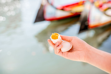 Holding portuguese delicacy called Ovos Moles made of egg yolks and sugar on the water channal...