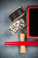 Chopsticks and soy sauce on stone concrete board