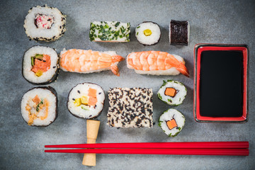 Sushi on stone or concrete slate with chopsticks