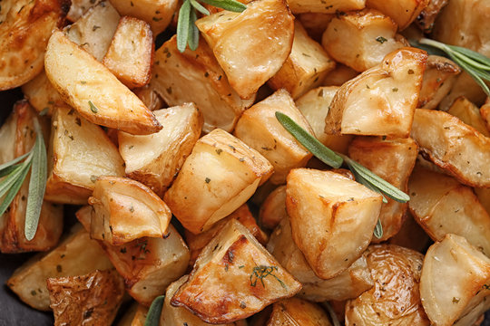 Delicious baked potatoes with rosemary, closeup