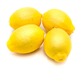 Group of four whole yellow lemons isolated on white background .
