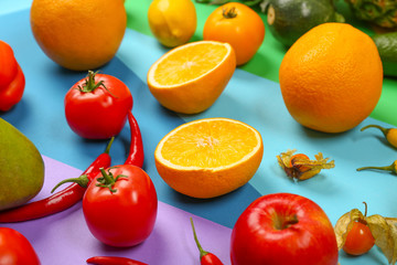 Many different fruits and vegetables on rainbow background