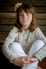 indoor portrait of happy smiling child girl sitting on beanbag on studio background