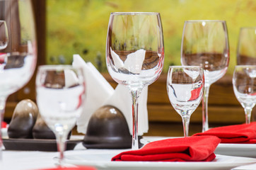 Served table with glasses, cutlery and napkins