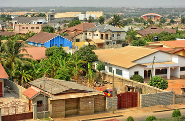 Modern residential buildings in Africa. Modern view. Suburb lifestyle in developing countries. Beautiful urban landscape. Top view. Wonderful houses with red tile roofs.