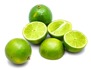 Group of whole and lime halves isolated on white studio background.