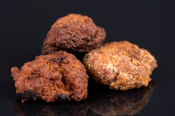Meatballs isolated above black background with reflections and copy space