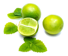 Limes and lemon balm leaves composition isolated on white background.