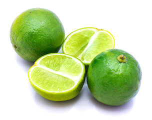 Two whole and two lime halves isolated on white studio background.