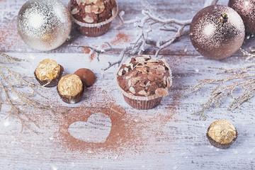 Tasty chocolate cupcake with sweets and winter decoration