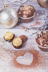 Tasty chocolate cupcake with sweets and winter decoration