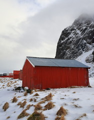 Corrugated steel and wooden red boathouses-mount Mustaren foot. Eggum-Vestvagoya-Lofoten-Norway. 0543