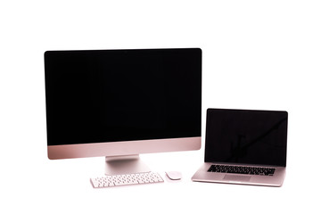 Laptop and computer screen on a white table with reflection on white background